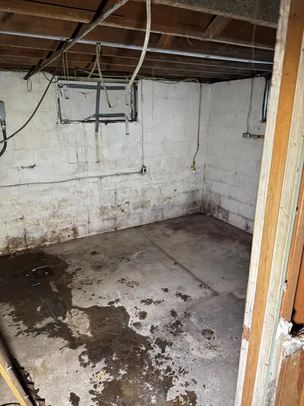 The same basement swept and empty, after